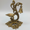 Decorative brass lamp with bell on a white background