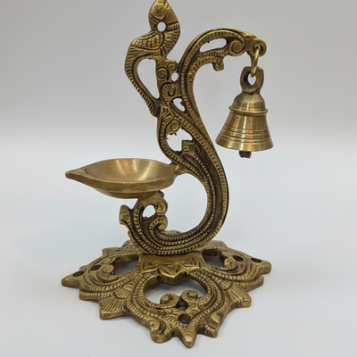 Decorative brass lamp with bell on a white background